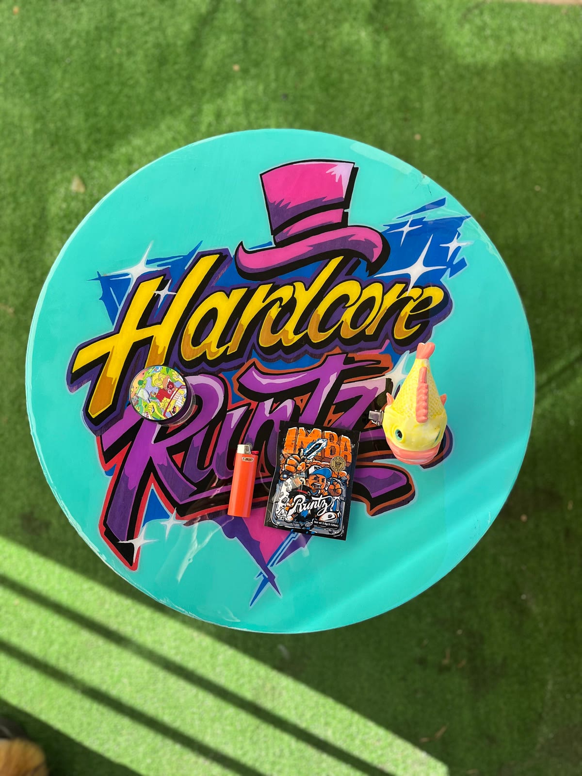 Hardcore Rolling Table — a round teal table with graffiti lettering.