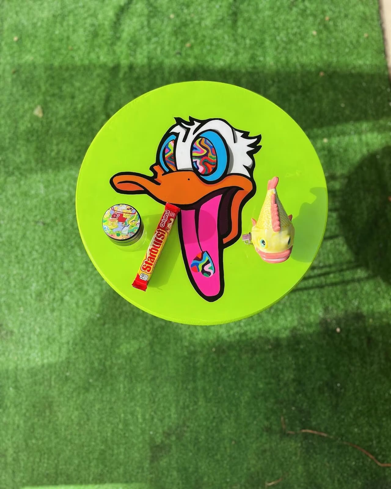 Trippy Table — a round lime table with a cartoon duck face.